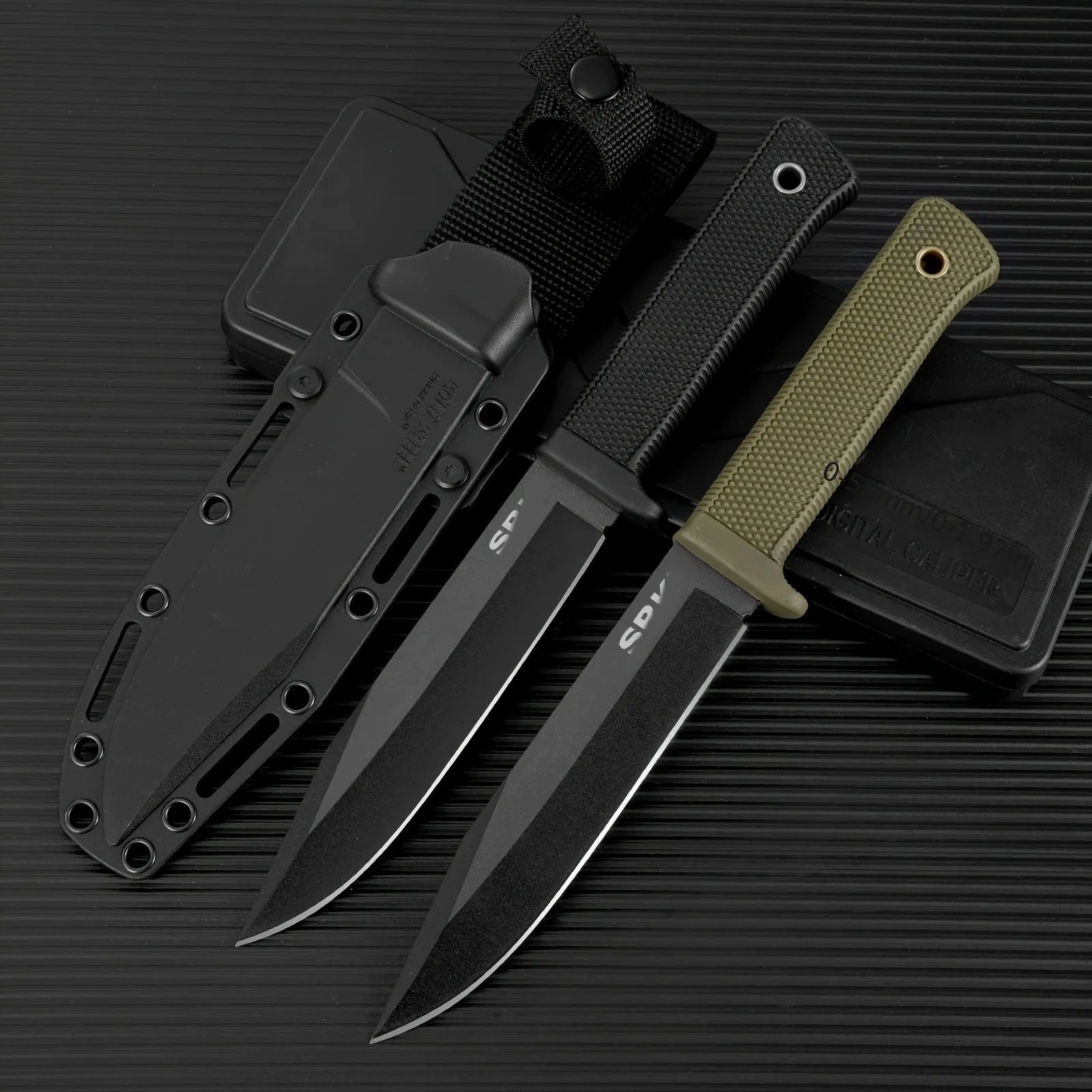 Set of three knives with black sheaths on a dark background