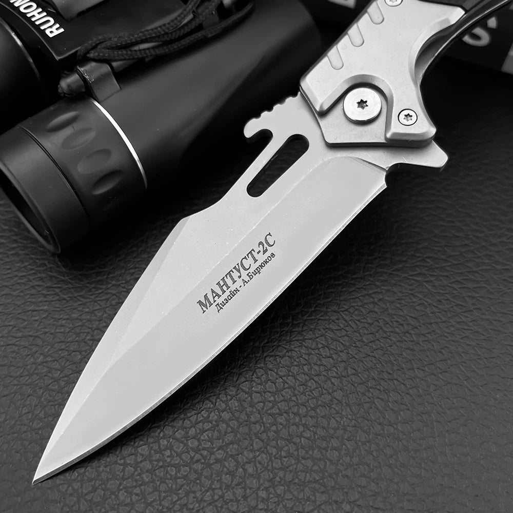 Folding knife with engraved text on a textured surface