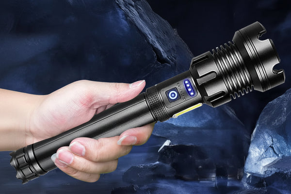 Hand holding a flashlight with three mode indicators against a dark background