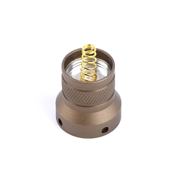 Bronze metal component with a gold spring on a white background